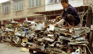 Man with electronic waste at recycling depot in China