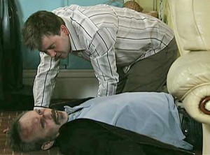 John looking at Colin, dead in the living room