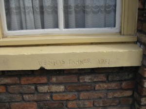 carving of name Dennis Tanner at No. 11 Coronation Street