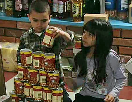 twins make soup tin pyramid in shop
