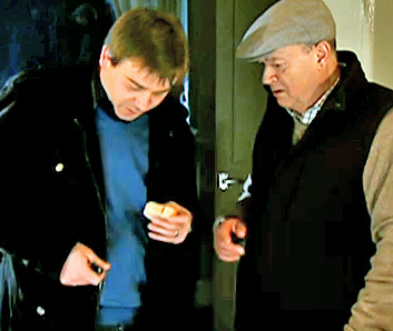 Clarence looking at bread John has pulled from his pocket