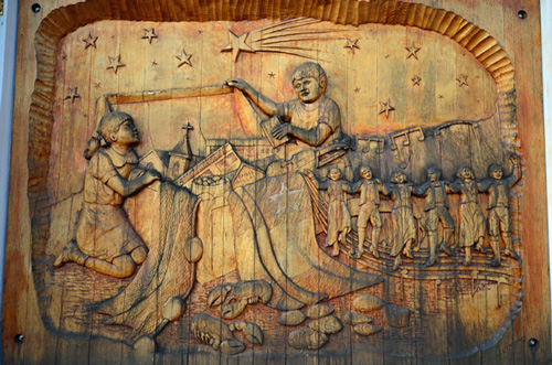 carved panel telling Acadian history on side of Museum building, Miscouche carved panel telling Acadian history on side of Museum building, Miscouche photo j stewart
